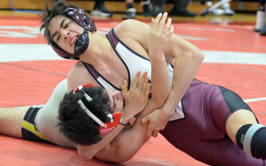 Matthew C. Perry's John Shaver locks in an head-and-arm hold on Nile C. Kinnick's Austin Shinzato at 129 pounds. Shaver won by pin in 2 minutes, 39 seconds and finished second in the weight class.