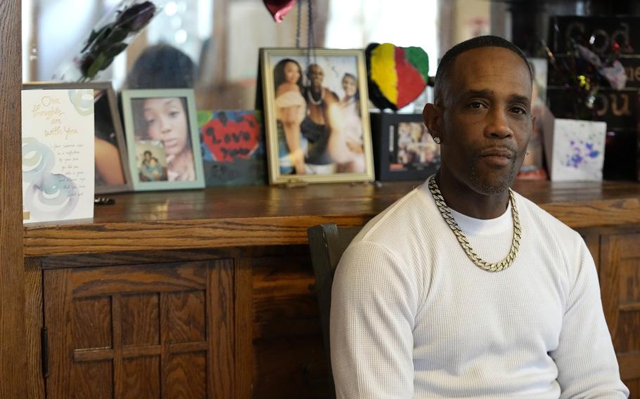 Damone Presley sits next to a memorial area in his house for his daughter, Nitosha, Thursday, May 4, 2023, in St. Paul, Minn. Nitosha and her three friends were found shot to death inside an SUV in the middle of a Wisconsin cornfield, though they were killed in St. Paul.