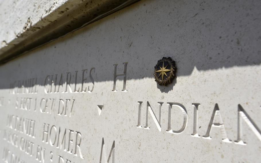 The name of Army Master Sgt. Charles H. McDaniel Sr. carved into a wall of the Courts of the Missing at the National Memorial Cemetery of the Pacific in Hawaii is shown in 2018 with a rosette placed next to it, symbolizing he has been accounted for. 