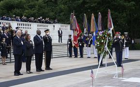 President Joe Biden, left, joined by, from left, Vice President Kamala Harris, Defense Secretary Lloyd Austin and Army Major Gen. Trevor Bradenkamp, listen to the playing of Taps during an Armed Forces Full Honors Wreath Ceremony at the Tomb of the Unknown Soldier at Arlington National Cemetery in Arlington, Va., on Memorial Day, Monday, May 27, 2024. (AP Photo/Susan Walsh)