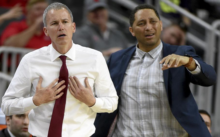 Head coach Andy Enfield, left, and associate head coach Tony Bland of the USC Trojans react during a quarterfinal game of the Pac-12 Basketball Tournament against the UCLA Bruins at T-Mobile Arena in Las Vegas, Nevada, on March 9, 2017.