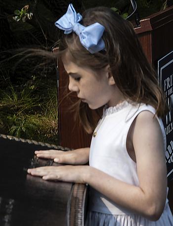 Charlotte Roosevelt, great-great granddaughter of President Franklin D. Roosevelt, touches FDR’s signature on the new prayer plaque at the National World War II Memorial in Washington, D.C., on the 79th anniversary of the start of the D-Day invasion, Tuesday, June 6, 2023.