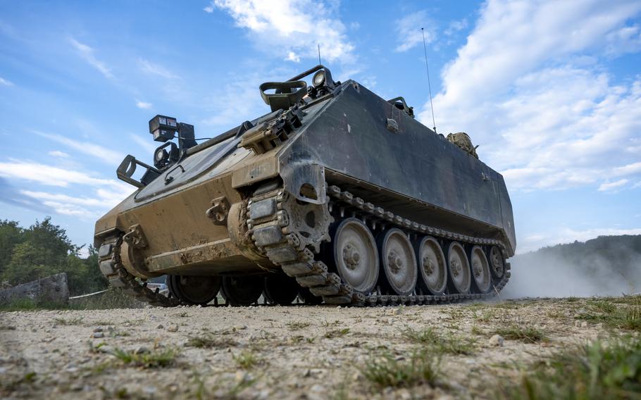 An M113-OSV armored personnel carrier rolls through a training village during Saber Junction 23 at the Joint Multinational Readiness Center near Hohenfels, Germany, Sept. 13, 2023. Eight soldiers were injured Tuesday during a nighttime tactical movement in Hohenfels when two M113s collided at a slow speed.