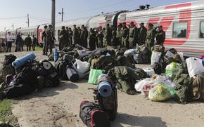 Russian recruits gather to take a train at a railway station in Prudboi, Volgograd region of Russia, Thursday, Sept. 29, 2022. Russian President Vladimir Putin has ordered a partial mobilization of reservists to beef up his forces in Ukraine. (AP Photo)