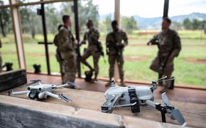 Two small unmanned aircraft systems, also known as "drones," are set up for use during Exercise NEXUS FORGE, Feb. 5, 2025, at Schofield Barracks, Hawaii. As small UAS threats evolve, so must the systems and training used to counter them, with continued investment in AI-driven detection, directed radio frequency weapons and next-generation electronic warfare solutions. (U.S. Air Force photo by Master Sgt. Jeffrey Grossi)