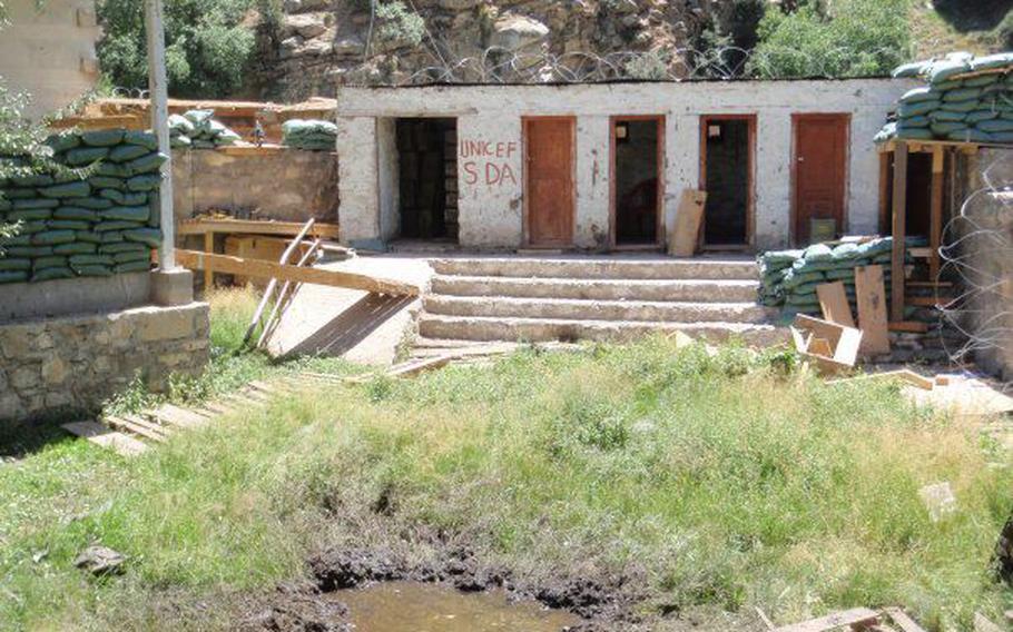 An outbuilding at ''the girls' schoolhouse' in the district center of Barg-e Matal in the northeastern Afghan province of Nuristan. The building served as an ammunition supply point housing hundreds of rocket-propelled grenades and other ammo for use by Afghan security forces and was later hit by an RPG that set fire to the stockpile during an attack in early August 2009 where Adam Holroyd earned a Silver Star for suppressing both the flames and the attack.