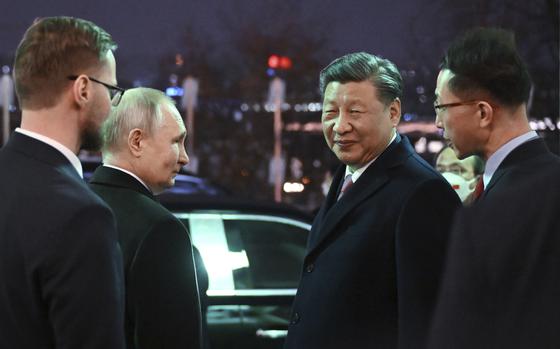 Chinese President Xi Jinping, right, and Russian President Vladimir Putin talk to each other prior to Chinese President Xi Jinping leaving after their dinner at The Palace of the Facets in the Moscow Kremlin, Russia, Tuesday, March 21, 2023.