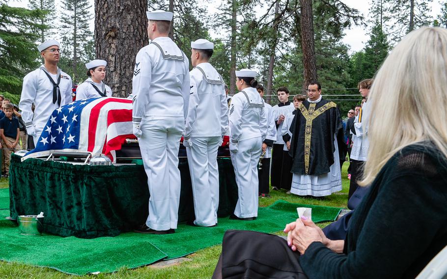 Louann Daley, retired Lt. Cmdr. Lou Conter’s daughter, looks on as Navy Reserve Center Sacramento funeral honor detail sailors stand at attention around Conter’s casket during his memorial service.
