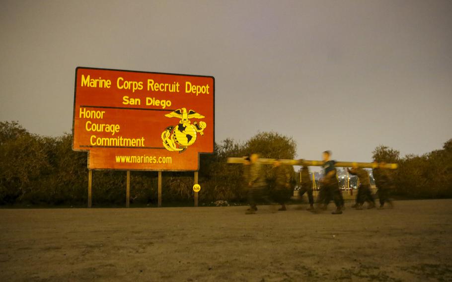 Marines of Support Battalion make their way across the back trail of the three-mile course during the log race at Marine Corps Recruit Depot San Diego.