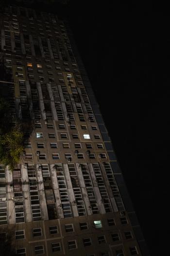 Only a few lights can be seen in an apartment building in Dnipro, Ukraine. Russia’s recent waves of missile launches have caused sporadic blackouts. 