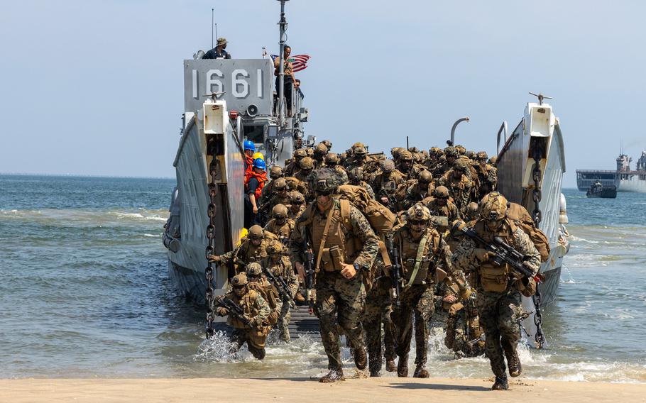 Marines runs on land from a ship.