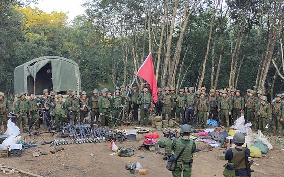 Members of the Myanmar National Democratic Alliance Army pose for a photograph with the weapons allegedly seized from the Myanmar's army outpost on a hill in Chinshwehaw town, Myanmar, Saturday Oct. 28, 2023. The leader of Myanmar’s army-installed government said the military will carry out counter-attacks against a powerful alliance of ethnic armed groups that has seized towns near the Chinese border in the country’s northeastern and northern regions, state-run media reported Friday Nov. 3, 2023. ("The Kokang" online media via AP)