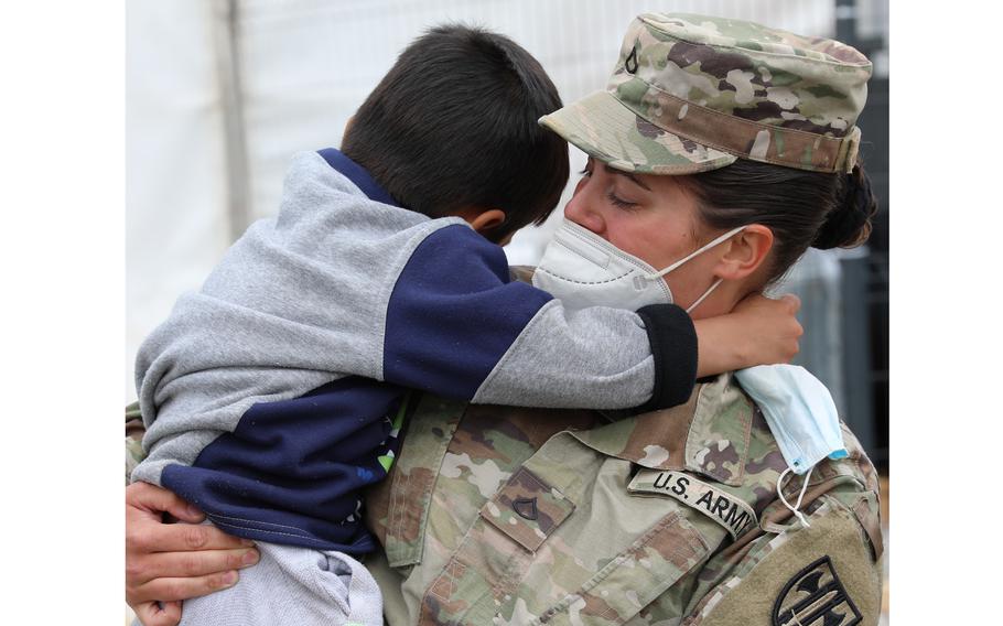 U.S. Army Pfc. Melissa Baker, Task Force Ever Vigilant, comforts an Afghan evacuee at Camp Liya, Kosovo, October 1, 2021. Camp Liya 