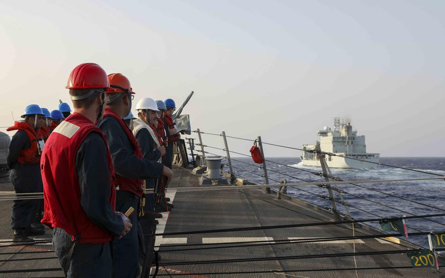 Sailors assigned to guided-missile destroyer USS Truxtun prepare to conduct a replenishment-at-sea with Canadian Naval Replenishment Unit Motor Vessel Asterix in the Red Sea on April 25, 2023. The Truxtun, USS Lewis B. Puller and USNS Brunswick are positioned off the coast of Sudan to help evacuate Americans from the war-torn country if needed.