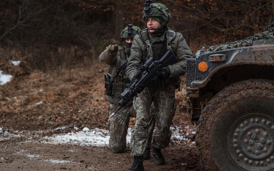Lithuanian soldiers react to contact during exercise Allied Spirit in Hohenfels Training Area, Germany, on Jan. 24, 2022. This year's version of the exercise began Feb. 26 and includes 6,500 troops from the United States and allied nations.