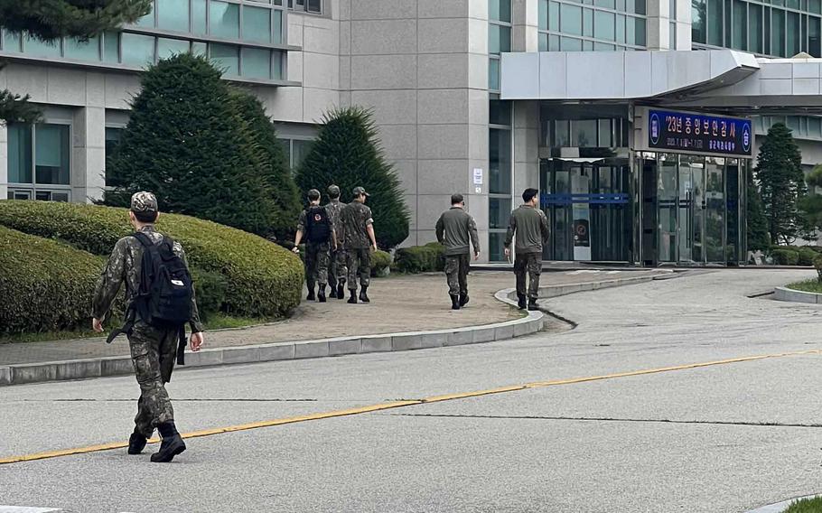 South Korean service members walk toward the operations command building at Osan Air Base, South Korea, Thursday, July 6, 2023.