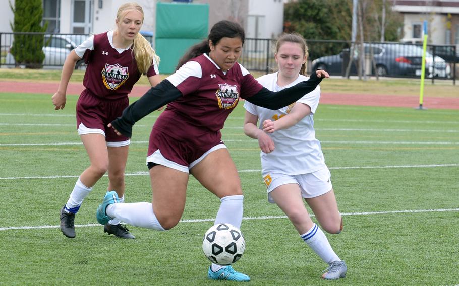 Matthew C. Perry's Markeen Lutz and Yokota's Hailey Riddels battle for the ball during Saturday's DODEA-Japan girls soccer match. The teams played to a 2-2 draw.