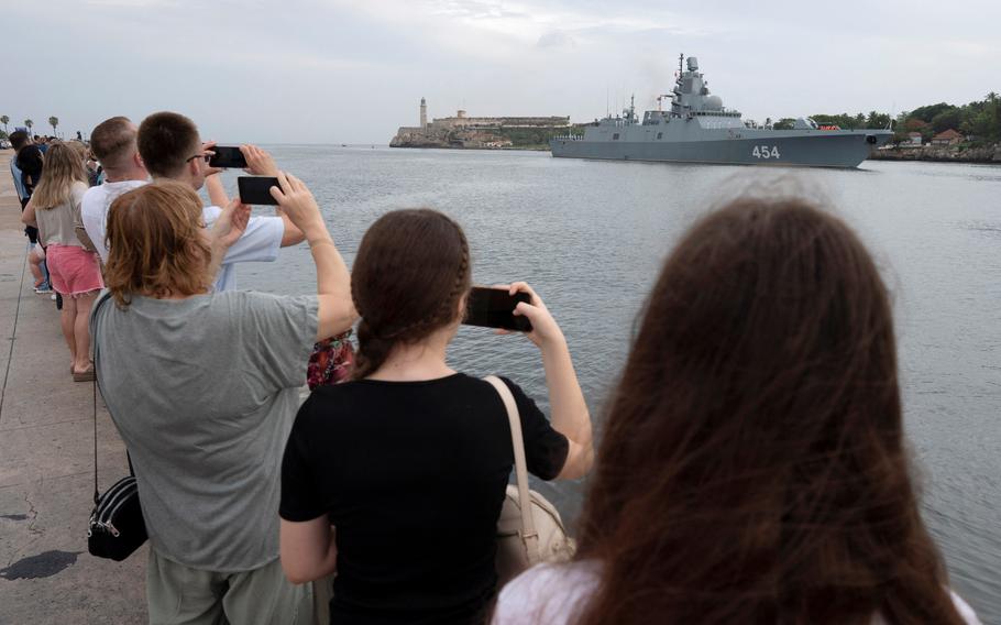 Members of the Russian community watch Russian frigate Admiral Gorshkov as it enters the bay in Havana, Cuba, June 12, 2024. 