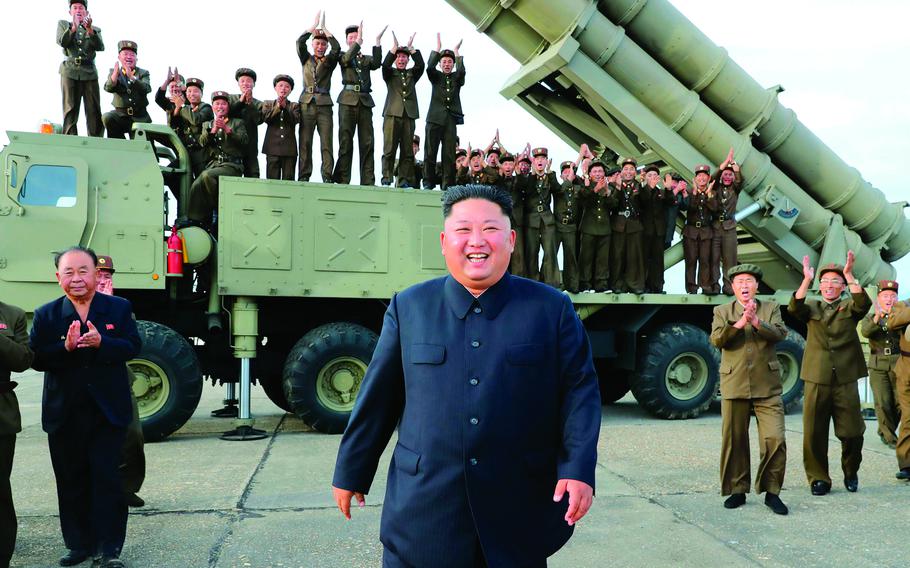 In this photo from the Korean Central New Agency, North Korean leader Kim Jong Un smiles after the test-firing of an unspecified missile at an undisclosed location, Aug. 24, 2019. 