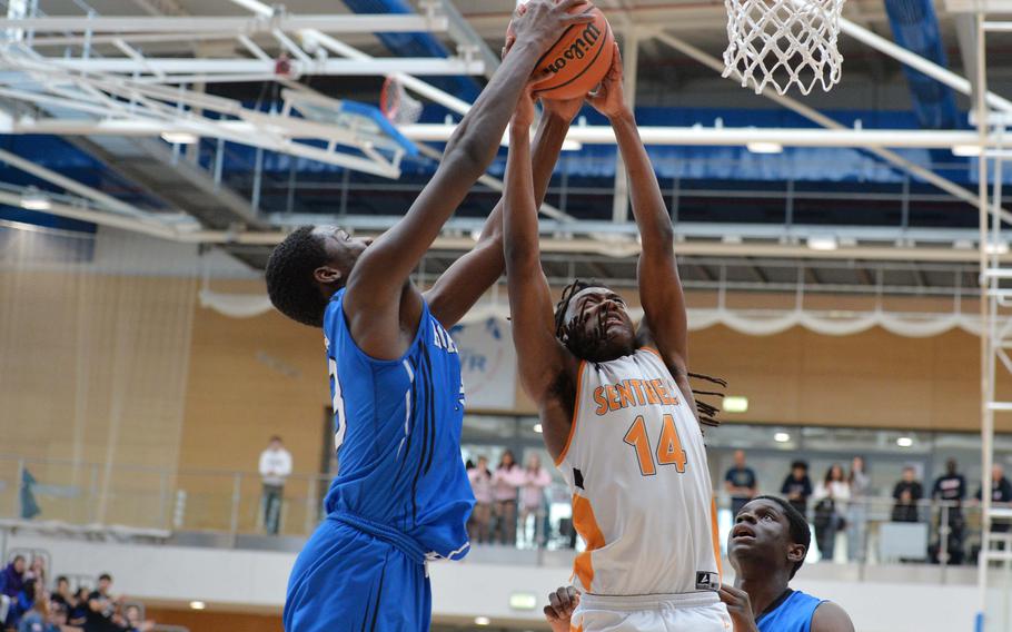 Jacob Idowu of Hohenfels and Spangdahlem’s Messiah Smith fight for a rebound in the boys Division III final at the DODEA-Europe basketball championships in Wiesbaden, Germany, Feb. 17, 2024. Spangdahlem beat Hohenfels in a close game 65-63.