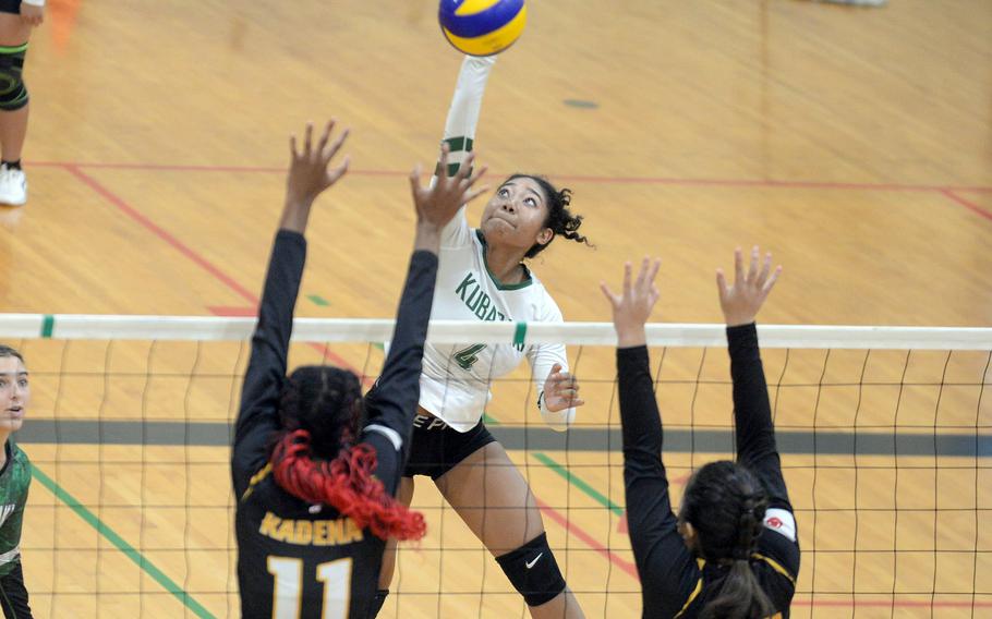 Kubasaki's Risha McGriff spikes against Kadena's Liza Young and Christina Kehe during Tuesday's Okinawa girls volleyball match. The Dragons won in four sets.