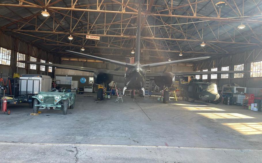 A Vietnam-era Bell UH-1 Iroquois military utility helicopter, right, arrived at its final resting place at Woodring Wall of Honor and Veterans Park in Enid, Okla., on Monday. A World War II jeep that will be displayed in the museum is at left.