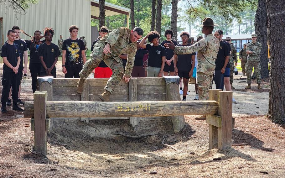 Drill sergeants with 4th Battalion, 39th Infantry Regiment, demonstrate an obstacle July 8, 2023, at the Fit to Win 2 course as part of a Future Soldier for a Day recruiting event at Fort Jackson, S.C.