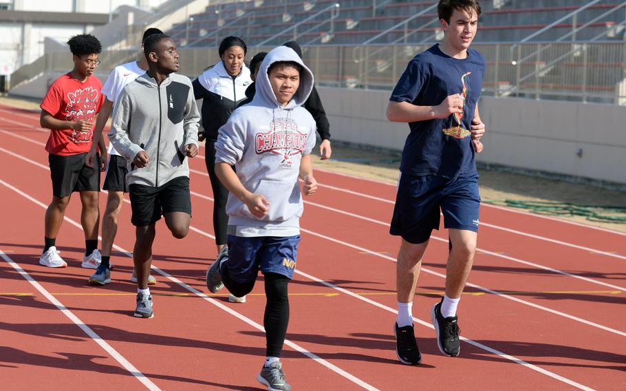 Senior Zildjian Tamayo, in hoodie, is expected to run the 400, 800 and 1,600 relay for Matthew C. Perry.