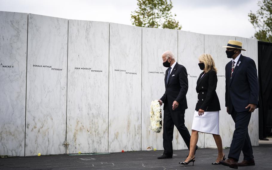 Joe Biden, then the Democratic presidential nominee, with wife Jill Biden, lays a wreath at the wall of names at the Flight 93 National Memorial on Sept. 11, 2020, in Shanksville, Pa. 