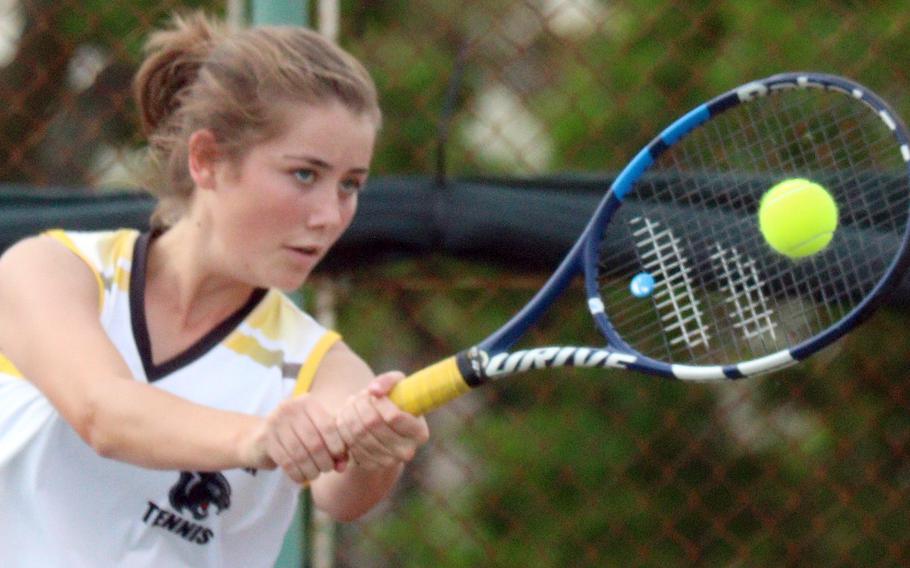 Kadena's Mary Tracy belts a two-handed backhand shot against Kubasaki's Ella Perez during Wednesday's Okinawa tennis matches. Tracy won 8-4.