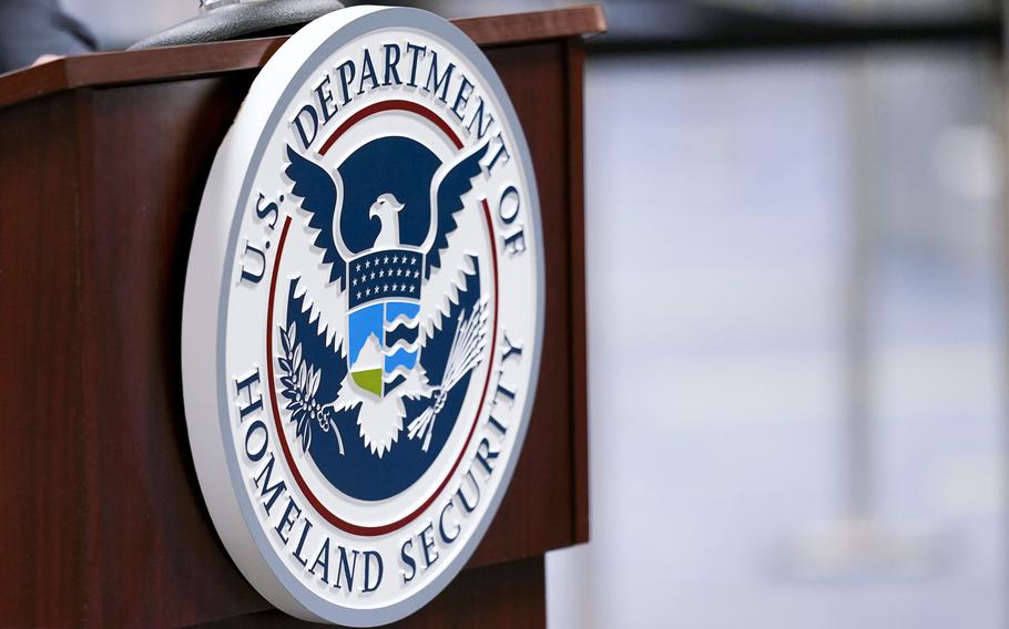 A U.S. Department of Homeland Security plaque is displayed a podium as international passengers arrive at Miami international Airport where they are screened by U.S. Customs and Border Protection, Nov. 20, 2020, in Miami. 