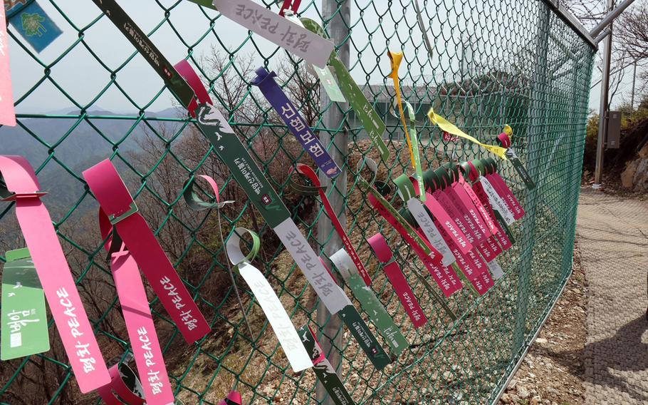 Peace ribbons hang from a barbed wire fence on Baegamsan Mountain in Hwacheon County, South Korea, near the border with the North, May 2, 2023. 