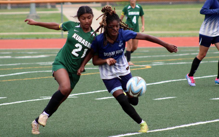 Kubasaki's Solares Solano and Guam High's Ny'Kale Penn chase the ball.