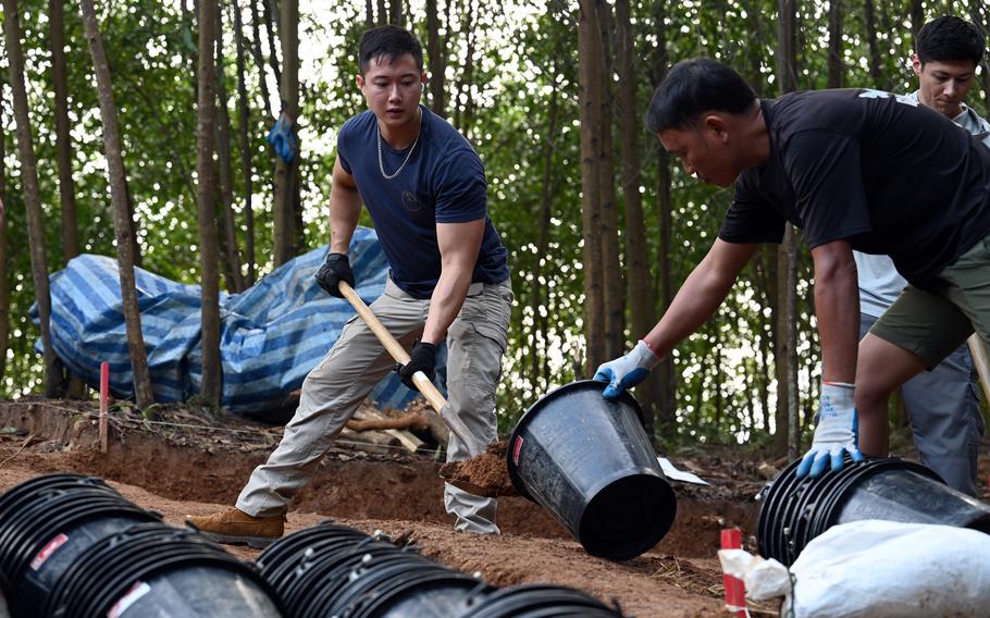 Personnel with the Defense POW/MIA Accounting Agency collect soil during a recovery mission in Vietnam, Nov. 22, 2023. 