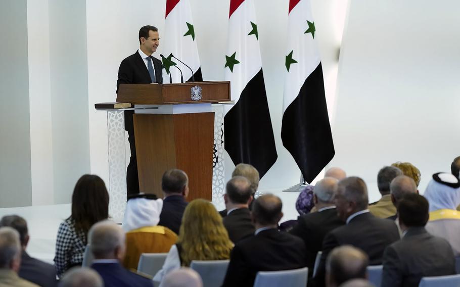 In this photo released by the official Facebook page of the Syrian Presidency, Syrian President Bashar Assad takes the oath of office for a fourth seven-year term, at the Syrian Presidential Palace in the capital Damascus, Syria, Saturday, July 17, 2021.