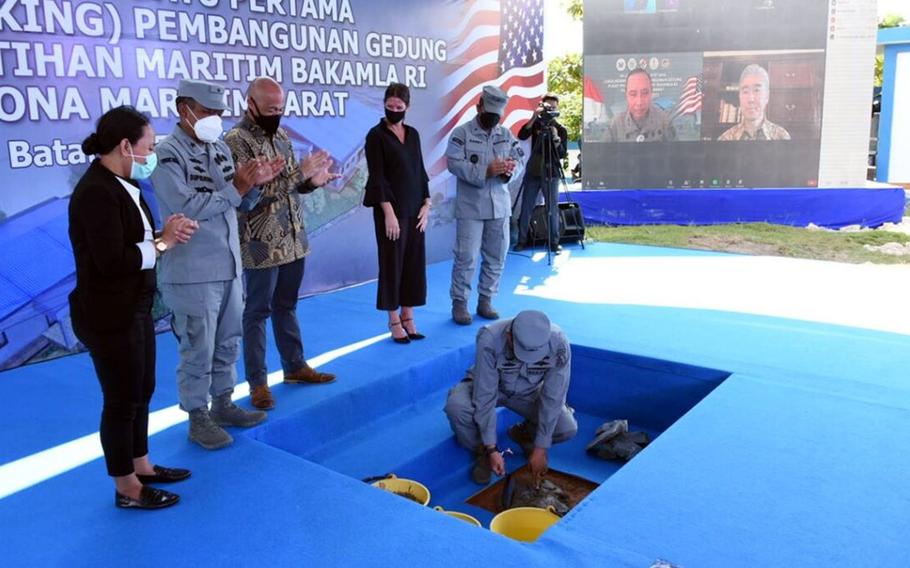 Representatives from the U.S. and Indonesia break ground on a maritime training center in Batam, Indonesia, Friday, June 25, 2021. The center is being built near the mouth of the Malacca Strait, a prime global shipping channel linking the Indian and Pacific oceans. 