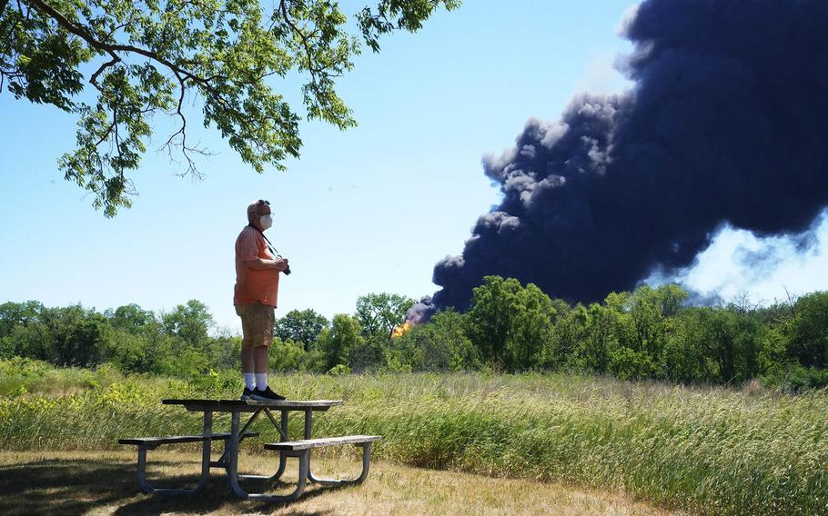 Neal Nuber, of South Beloit, watches the chemical fire at Chemtool Incorporated factory from the J. Norman Jensen Forest Preserve in South Beloit, Illinois, on June 14, 2021.