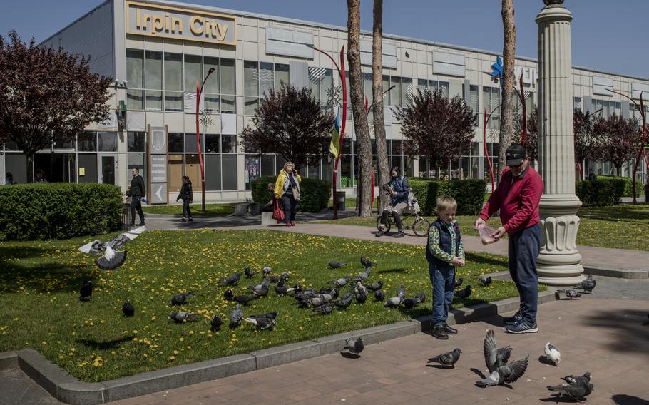 People near the World War II memorial in the town center of Irpin. Across Ukraine, Victory Day was the quietest day of the war so far.