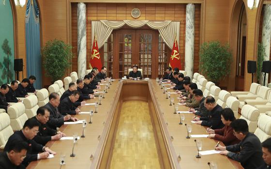 North Korean leader Kim Jong Un, center, leads the 6th Meeting of the 8th Central Committee on Jan. 19, 2022. 