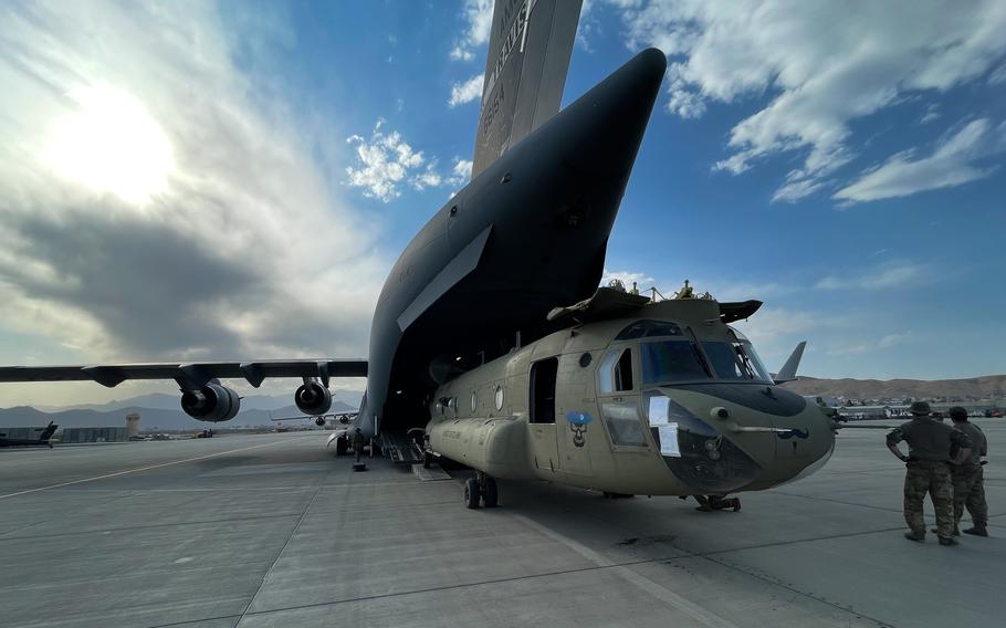 A CH-47 Chinook from the 82nd Combat Aviation Brigade, 82nd Airborne Division is loaded onto a U.S. Air Force C-17 Globemaster III at Hamid Karzai International Airport in Kabul, Afghanistan, on Aug. 28, 2021. 