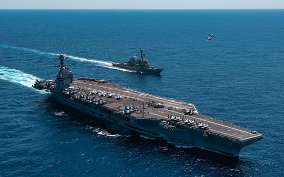 An F/A-18F Super Hornet, attached to the "Blacklions" of Strike Fighter Squadron (VFA) 213 and a F/A-18E Super Hornet, attached to the "Golden Warriors" of Strike Fighter Squadron (VFA) 87 fly over the world's largest aircraft carrier, USS Gerald R. Ford (CVN 78), the Arleigh Burke-class guided-missile destroyer USS Mahan (DDG 72), April 11, 2025. The Gerald R. Ford Carrier Strike Group is underway in the Atlantic Ocean completing integrated naval warfighting training. Composite Training Unit Exercise (COMPTUEX) is the Joint Force’s most complex integrated training event and prepares naval task forces for sustained high-end Joint and combined combat. Integrated naval training provides America’s civilian leaders and commanders highly-capable forces that deter adversaries, underpin American security and economic prosperity, and reassure Allies and partners. (U.S. Navy photo by Mass Communication Specialist 2nd Class Maxwell Orlosky