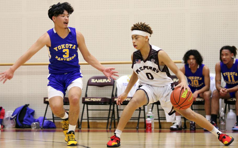 Matthew C. Perry's Jahiion Francois dribbles against Yokota's Dylan Tomas during Friday's DODEA-Japan season-opening boys basketball game. The Panthers won 59-27.
