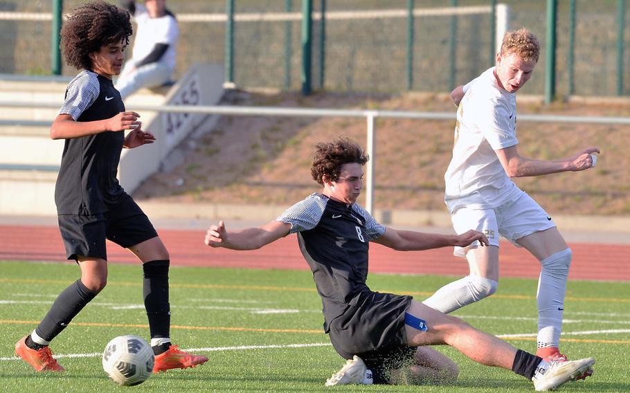 Ramstein’s Joseph Jost centers the ball past Stuttgart’s Triston Milletich to teammate Santiago Idarraga for the Royals’ first goal in their 2-0 win over the Panthers at the DODEA-Europe soccer championships in Ramstein, Germany, May 22, 2025. 