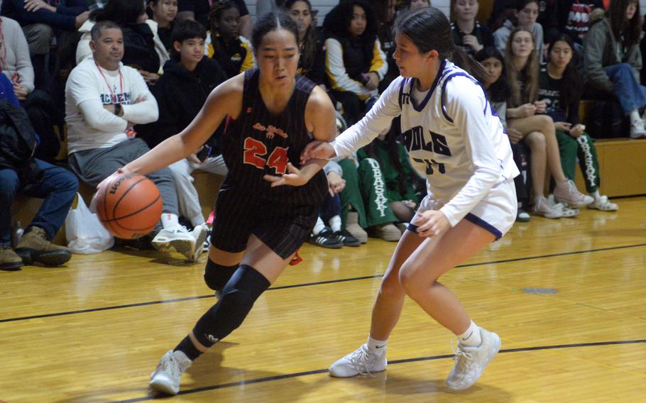 Nile C. Kinnick's Kotone Turner drives against Academy of Our Lady of Guam's Pia Hart. The Red Devils won 41-28 to stay unbeaten at 15-0.