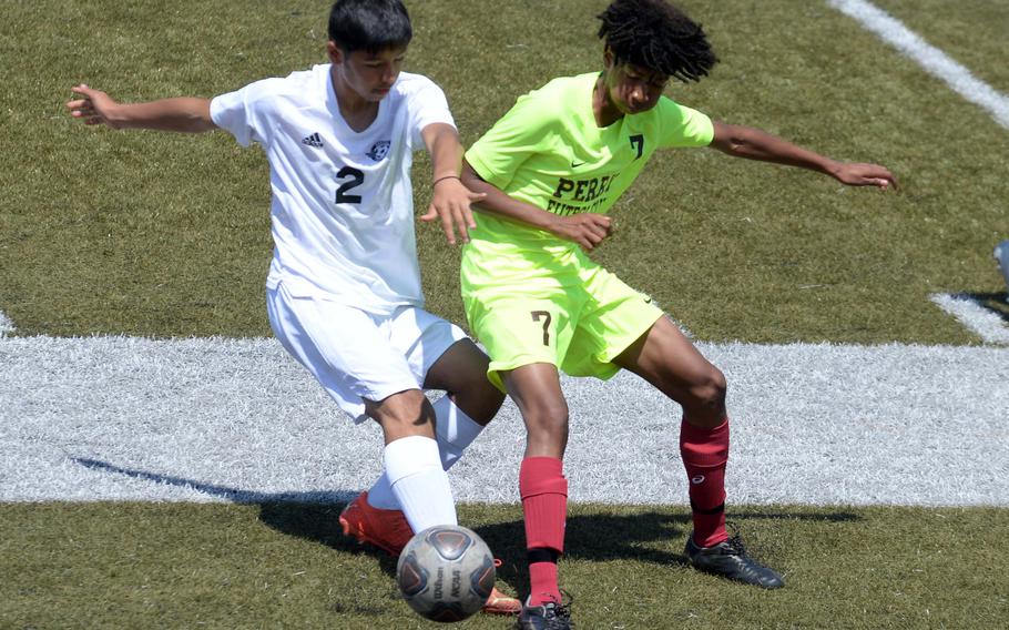 Kadena's Alberto Nakamoto and Matthew C. Perry's Keith Eiwing scramble for the ball during Saturday's DODEA interdistrict boys soccer match. The Panthers won 2-0.