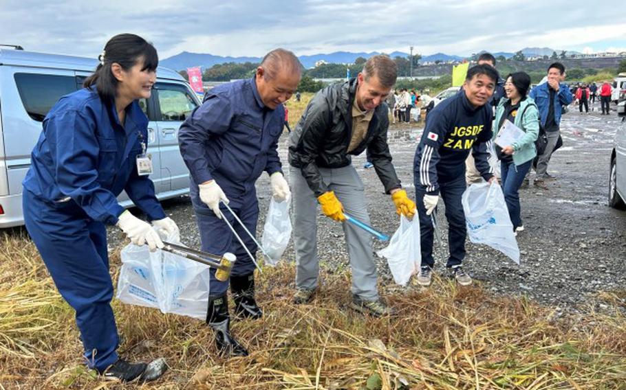 From left, Zama City Mayor Mito Sato, Sagamihara City Mayor Kentaro Motomura, U.S. Army Garrison Commander Col. Marcus Hunter, and 4th Engineer Group and Japan Ground Self-Defense Force Camp Zama Commander Col. Kenji Honda work shoulder to shoulder cleaning the Sagamihara City Shindo Sports Park during a volunteer event there Oct. 29.
