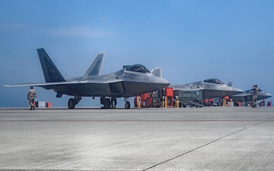 Airmen conduct preflight inspection on three Air Force F-22 Raptors during Agile Combat Employment training at Marine Corps Air Station Iwakuni, Japan, June 22, 2022. 