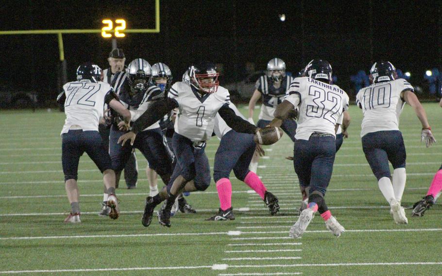 Lancers running back Jon Wilson takes a hand off by quarterback Dante Thompson in the game against Bristol Academy.