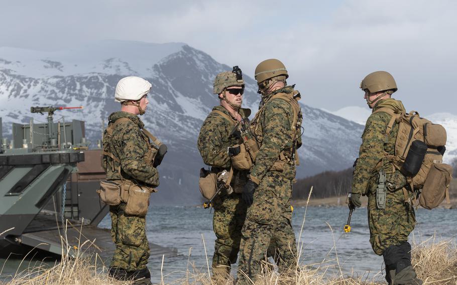 Marine Staff Sgt. Samuel Whitehead speaks to his team during a multinational amphibious landing in Sandstrand, Norway, on March 21, 2022, as part of the Cold Response military exercise.