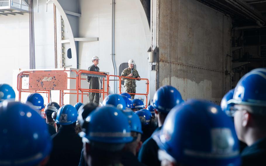 Master Chief Petty Officer of the Navy Russell Smith speaks at an all-hands call aboard the USS George Washington in Newport News, Va., on April 22, 2022. The ship has been in dry dock since 2017, and crew members expressed a range of frustrations to Smith. Three of the ship's sailors took their own lives between April 9 and April 15.